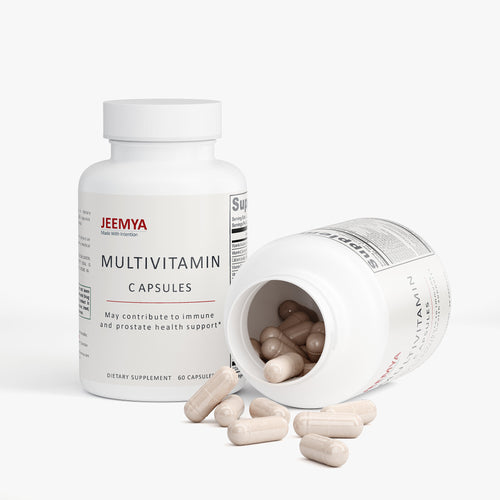 Two white bottles of JEEMYA Multivitamin Capsules on a plain white background. One bottle stands upright on the left. The second bottle lies on its side, tilted forward with several beige capsules spilling out onto the surface in front of it.