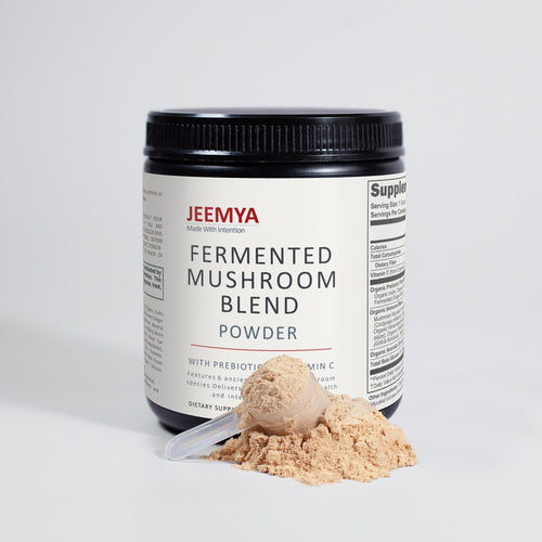 Front-facing container of Jeemya Fermented Mushroom Blend Powder with a small pile of mushroom powder on a clean white background.