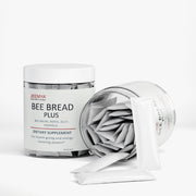 Jeemya Bee Bread Plus container with individually wrapped sachets partially removed from the open container, highlighting the single-serving stick pack format.
