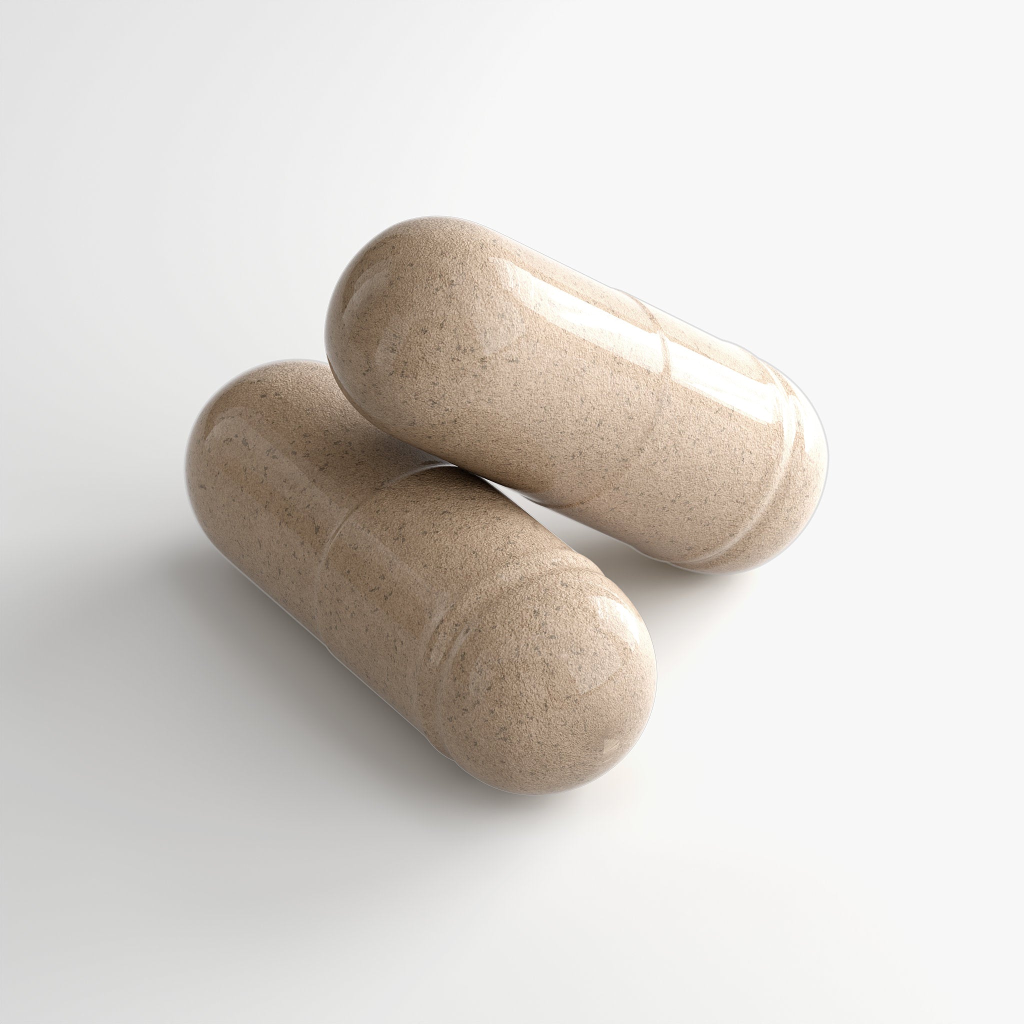 Close-up of two Ashwagandha Plus - Cortisol Supplement capsules formulated with adaptogens and vitamins to support stress management, energy production, and overall wellness.