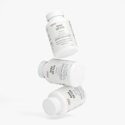 Creative arrangement of multiple Jeemya Max Detox supplement bottles floating at different angles, presenting the capsule packaging from several perspectives against a clean white background.