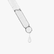 Glass dropper dispensing a clear drop of Jeemya Snail Mucin Face Serum, highlighting the lightweight liquid texture of the facial serum.