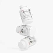 Multiple Jeemya Dental & Oral Health supplement bottles suspended in a creative floating arrangement, presenting the chewable oral health supplement from different viewing angles.